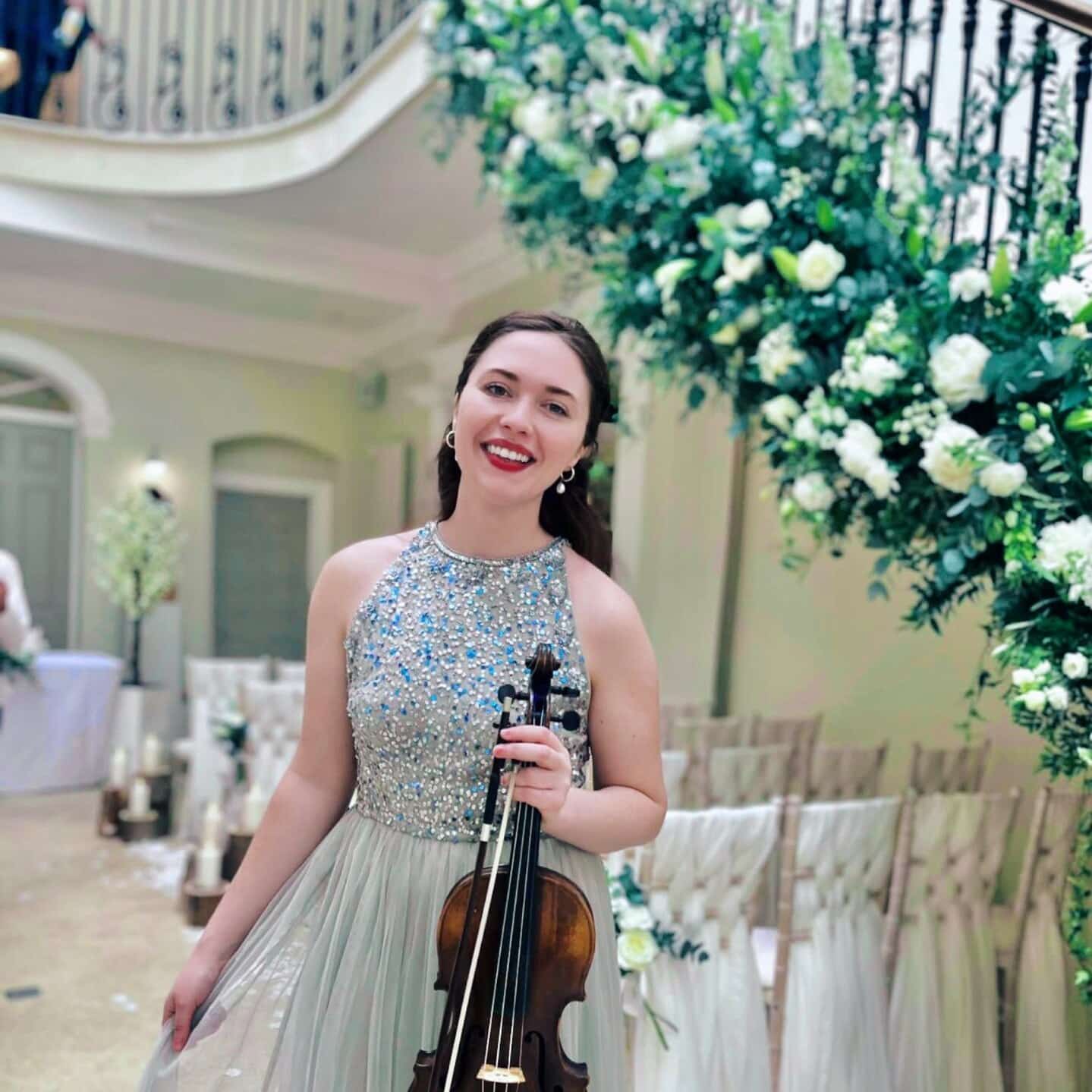 Aria with her violin at a wedding venue