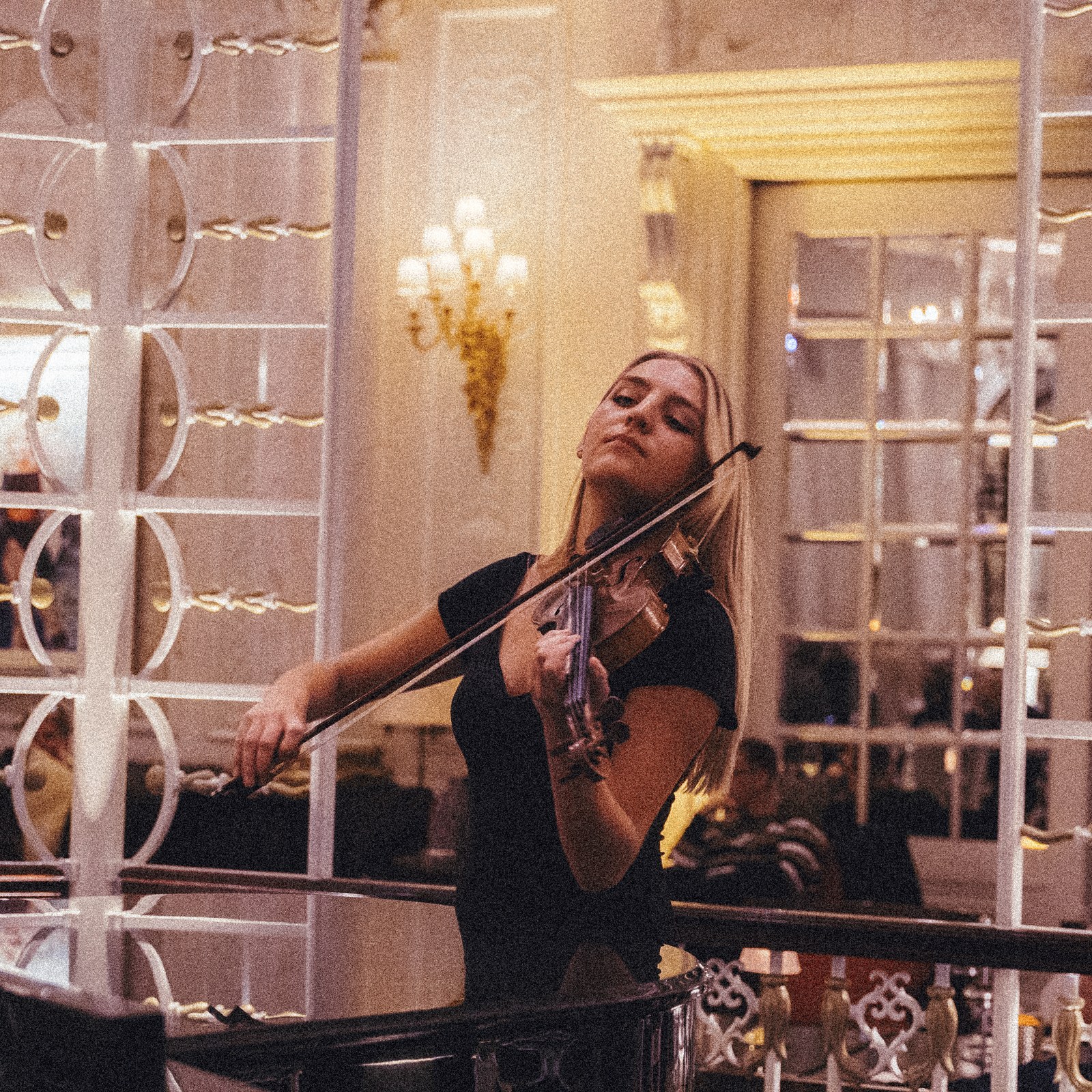 Lyra performing on the violin at a venue