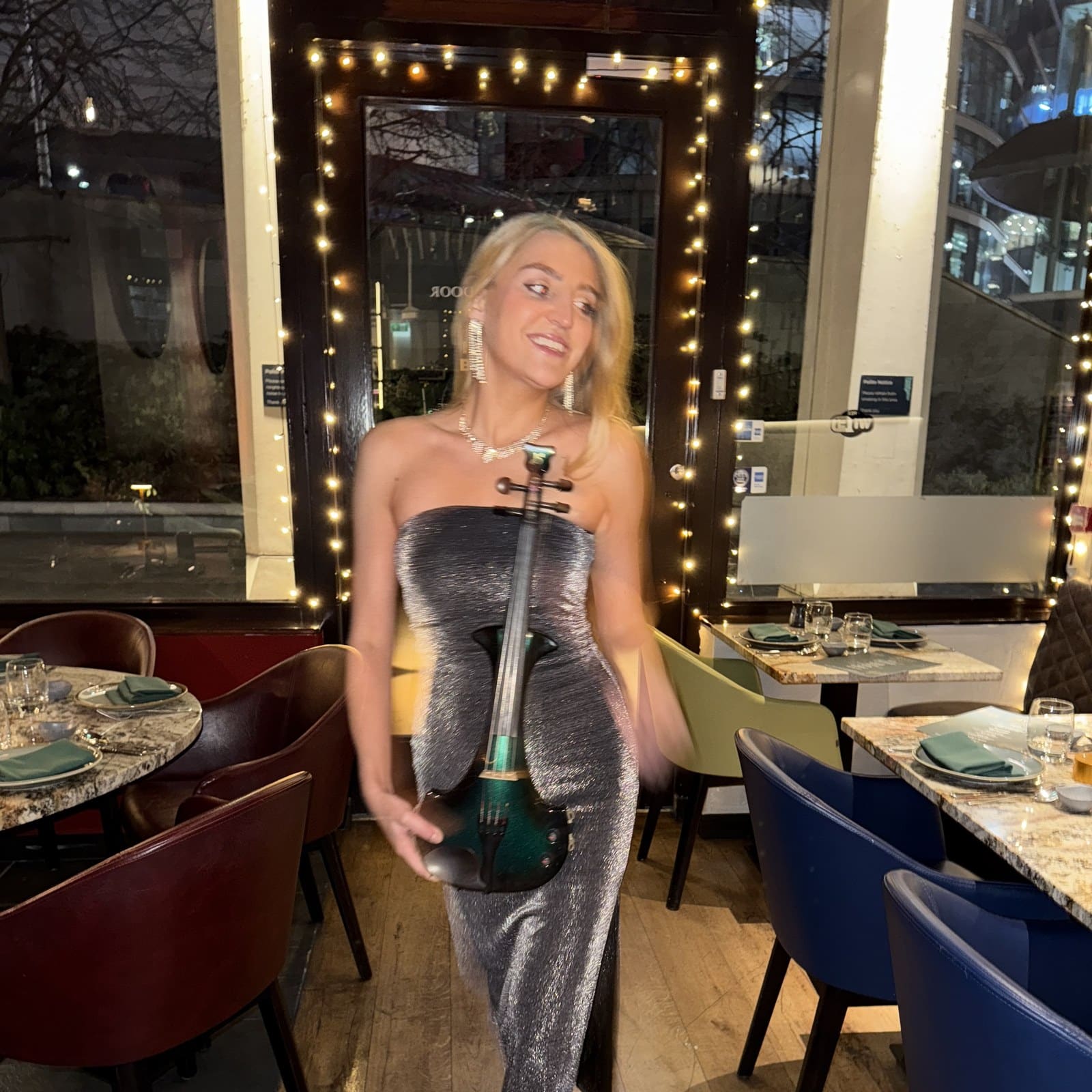 Lyra playing the violin at an evening reception