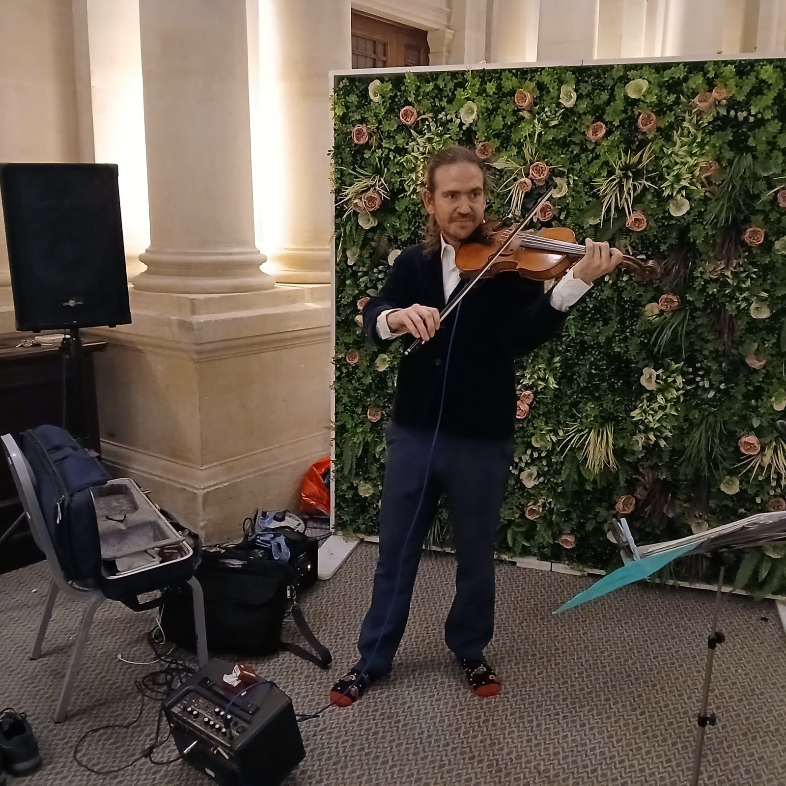 Rondo performing on the violin at a venue